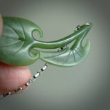 This photo shows a lily leaf drop pendant suspended from a silver clasp and silver chain. The jade is a lovely light flower jade and is a 3D lily design. A lovely soft New Zealand jade pendant carved for us by Josey Coyle.