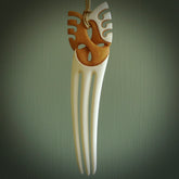 A hand carved bone and stained bone Heru comb. A large hand made Heru comb by New Zealand artist Kerry Thompson. Kerry has carved an exquisite work of art and would be perfect for an enthusiasts collection.