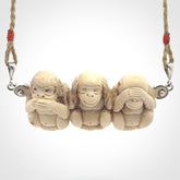 This is a hand carved deer antler three wise monkeys pendant. It is made from deer antler, bone. This is a large sized necklace and is a very unique, one only, pendant that has an adjustable tan cord. Hand carved deer antler three wise monkeys necklace for men and women. Hear, Speak, See no evil monkey pendant.