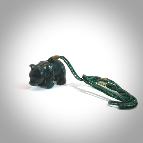 This picture shows a pendant that we designed in New Zealand jade. It is a little green bear that has a walking stance and is carved in detail. A really attractive and eye-catching piece of handmade jewellery. The cord is hand plaited braid in black and pale honey and the length can be adjusted.
