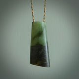 This photo shows a medium sized jade drop shaped pendant. It a a lovely, colourful douglas creek jade. The cord is a tan/green and is adjustable in length. One only large, contemporary drop necklace from Jade, by Rueben Tipene.