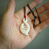 Hand carved twist with koru. Made from natural bone by NZ Pacific.