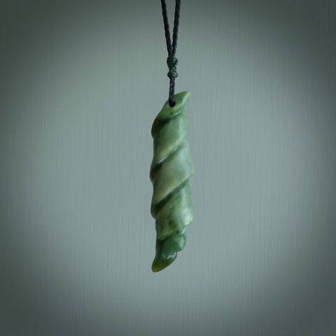 This is a unique complex twisted drop pendant, hand carved from New Zealand Jade. The cord is black and is length adjustable. This is delivered to you with Express Courier. Hand carved Pounamu, Jade necklace with adjustable cord from Ana Krakosky.