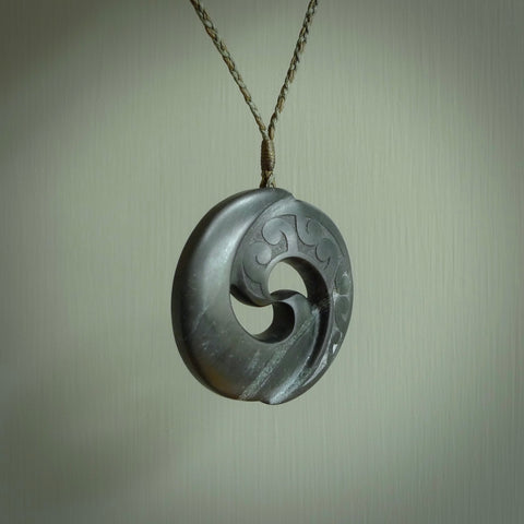 Hand made large New Zealand Pounamu, Jade Koru pendant. Hand carved in New Zealand by Rueben Tipene. Hand made jewellery. Unique large Greenstone Koru with adjustable cord. Free shipping worldwide.