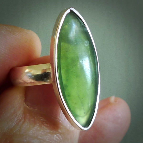 This is a handcrafted New Zealand Pounamu, Jade and sterling silver ring. This is a solid little work of art. We ship this worldwide for free and are happy to answer any questions that you may have about these or other products on our website. Delivered with Express Courier and packaged in a woven kete pouch.