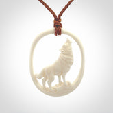 Hand carved bone wolf moon pendant.