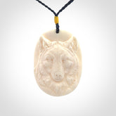 Hand carved bone wolf pendant.