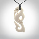 Hand carved bone manaia pendant with paua shell eye inlay. Hand made bone pendant.