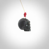 This picture shows a small sized Black Obsidian stone skull pendant that we have hand carved. It is polished to a soft shine and is a very striking piece. Provided with an adjustable meringue coloured cord.