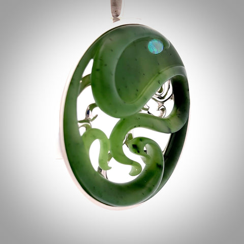 A hand carved New Zealand Jade and Sterling Silver Octopus pendant with Opal eye. Hand made by New Zealand artist Kerry Thompson.