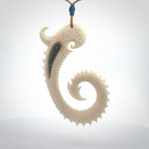 Hand carved dragon tail Bone with Paua shell inlay pendant.