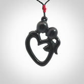 Hand carved Black Jade couples kissing in the shape of a heart pendant. Contemporary design is black jade. Pendants for lovers. Provided with adjustable cord.