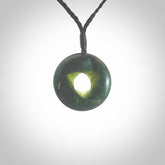 This small sized piece is a hand carved möbius ribbon pendant. Kyohei Noguchi has carved this from New Zealand Nephrite Jade. It has very subtle colour variations in the stone and is a delightful, small and artistic piece of jewellery. Delivered with an adjustable black cord.