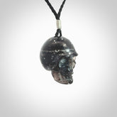 This picture shows a medium sized Snowflake Obsidian stone skull pendant that we have hand carved. It is polished to a soft shine and is a very striking piece. Provided with an adjustable black cord.