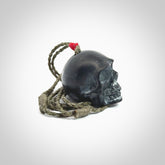This picture shows a large Black Obsidian stone skull pendant that we have hand carved. It is polished to a soft shine and is a very striking piece. Provided with an adjustable khaki cord.