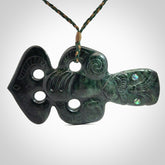 This is a large hand carved New Zealand Jade tiki pendant. It is made from New Zealand Jade and Paua shell.