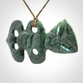 This is a large hand carved New Zealand Jade tiki pendant. It is made from New Zealand Jade and Paua shell.
