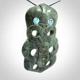 This is a large hand carved New Zealand Jade tiki pendant. It is made from New Zealand Jade and Paua shell.