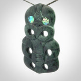 This is a large hand carved New Zealand Jade tiki pendant. It is made from New Zealand Jade and Paua shell.