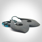 A hand carved large New Zealand Argillite double Hook, Matau, necklace. The cord is a black and blue coloured and is adjustable in length. A large sized hand made double hook necklace by New Zealand artist Rueben Tipene. One off work of art to wear.