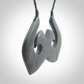 A hand carved large New Zealand Argillite double Hook, Matau, necklace. The cord is a black and blue coloured and is adjustable in length. A large sized hand made double hook necklace by New Zealand artist Rueben Tipene. One off work of art to wear.