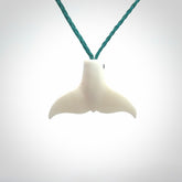 This is a lovely little Dolphin tail pendant. We have hand carved this in a bright, white bone and we make the necklace from a hand-plaited waxed cord. These are original NZ Pacific pendants, handmade from natural materials.