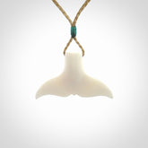 This is a lovely little Dolphin tail pendant. We have hand carved this in a bright, white bone and we make the necklace from a hand-plaited waxed cord. These are original NZ Pacific pendants, handmade from natural materials.