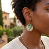 A woman wearing jade earrings