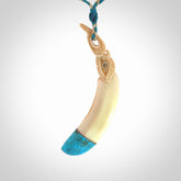 Hand carved Boars Tusk pendant with Turquoise, copper and Paua Shell. Engraved large boars tusk pendant. Unisex necklace hand carved by Andrew Doughty here in New Zealand. Unique art to wear. Delivered with an adjustable oat and cobalt blue cord.
