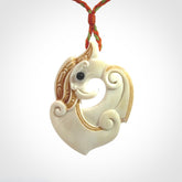 This picture shows a carved kea pendant in bone. It is provided with a hand-plaited orange and green cord that is length adjustable. Shipping is included and we ship worldwide.
