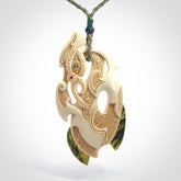This picture shows a carved manaia in bone with Jade and Paua shell. It is provided with a hand-plaited fern green cord that is length adjustable. Free shipping worldwide.