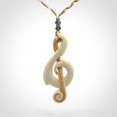 A Beautifully Carved Treble Clef Pendant in Bone