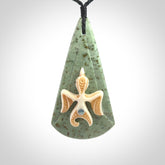 This is a wonderful New Zealand Jade and bone drop pendant with bird carving.
