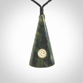 This is a wonderful New Zealand Jade drop pendant with whale bone koru and brass inlay.