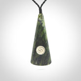 This is a wonderful New Zealand Jade drop pendant with whale bone koru and brass inlay.