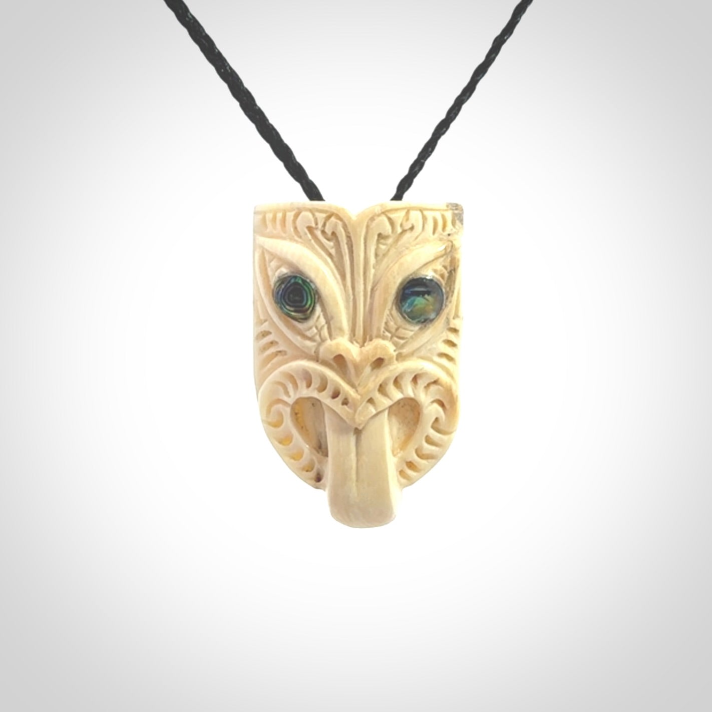 Hand carved Wheku pendant. Carved from woolly mammoth Tusk by NZ Pacific. Hand crafted Mammoth tusk jewellery for sale online. Provided with an adjustable cord and packaged in woven kete pouch.