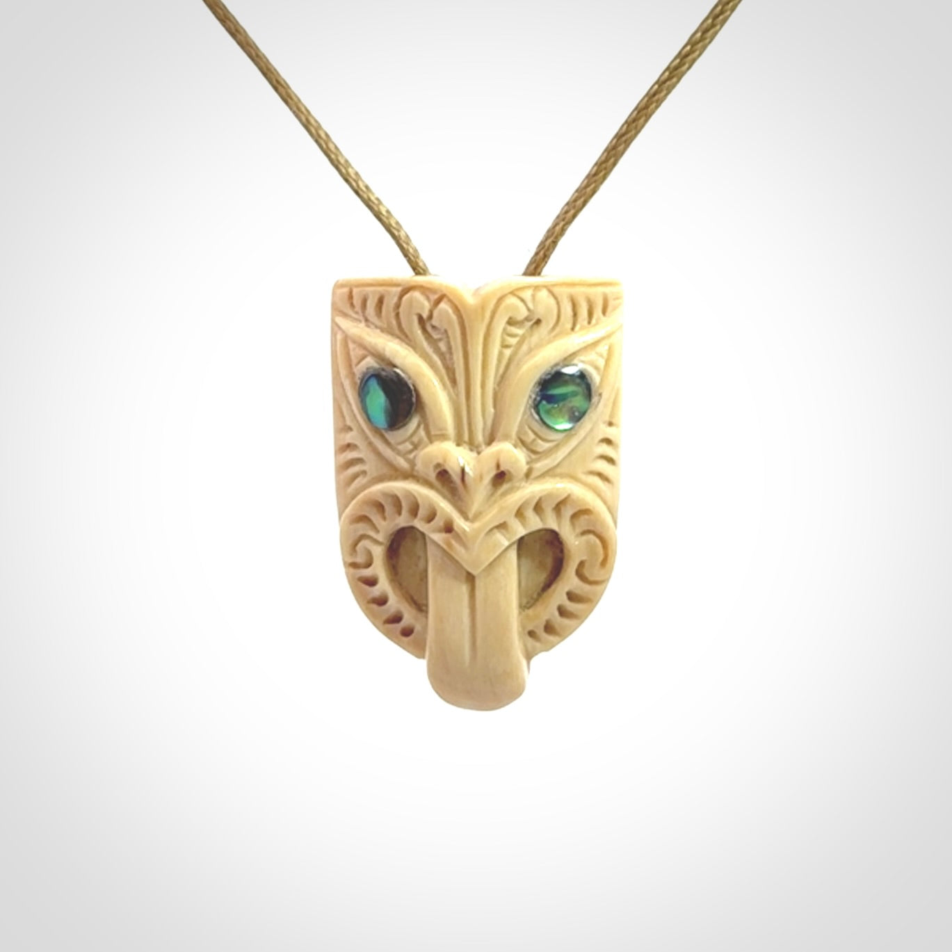 Hand carved Wheku pendant. Carved from woolly mammoth Tusk by NZ Pacific. Hand crafted Mammoth tusk jewellery for sale online. Provided with an adjustable cord and packaged in woven kete pouch.