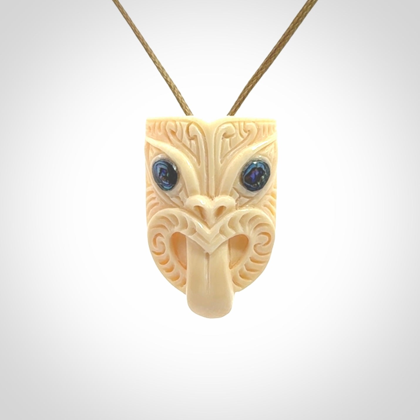 Hand carved Wheku pendant. Carved from woolly mammoth Tusk by NZ Pacific. Hand crafted Mammoth tusk jewellery for sale online. Provided with an adjustable cord and packaged in woven kete pouch.
