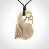 Hand made deer antler manaia pendant. Hand carved by NZ Pacific. Manaia carved from deer antler pendant for sale online. Delivered to you on an adjustable black cord and packaged in a woven kete pouch.