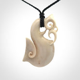 Hand made deer antler manaia pendant. Hand carved by NZ Pacific. Manaia carved from deer antler pendant for sale online. Delivered to you on an adjustable black cord and packaged in a woven kete pouch.
