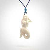 Hand carved natural bone mermaid pendant. Hand made from real bone. Art to wear. Provided with adjustable cord and packaged in a woven kete pouch.
