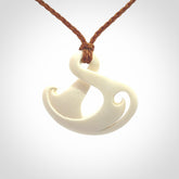 Hand carved bone twist pendant hand made by Peter Mitchell in New Zealand. This bone twist is provided with an adjustable gingernut cord and packaged in a woven kete pouch.