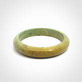 New Zealand flower jade bangle. This is carved from a solid piece of jade and polished to a mirror finish on the outside. The inside is a satin finish. The jade is high grade New Zealand Marsden and is a beautiful coloured stone.