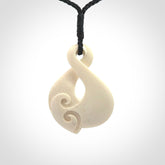 Hand carved bone twist pendant hand made by Peter Mitchell in New Zealand. This bone twist is provided with an adjustable black cord and packaged in a woven kete pouch.