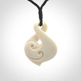 Hand carved bone twist pendant hand made by Peter Mitchell in New Zealand. This bone twist is provided with an adjustable black cord and packaged in a woven kete pouch.
