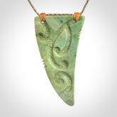 Hand carved New Zealand Flower jade Rei Puta pendant with four Koru engraving.