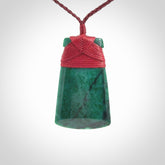 This is a handcrafted aotea stone Toki pendant.
