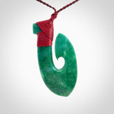 This is a handcrafted aotea stone Hook pendant.