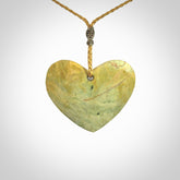A hand carved heart pendant made from New Zealand Flower jade.