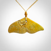 Hand carved New Zealand Flower Jade whale tail pendant.
